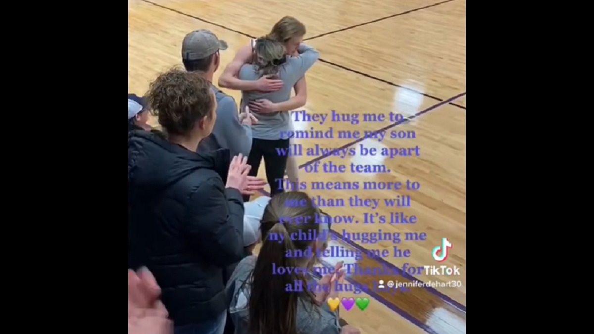 basketball players hug mom in place of late son